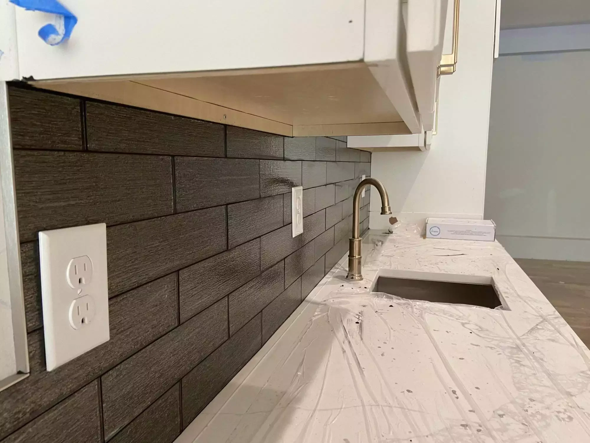 Kitchen renovation with modern backsplash and countertops