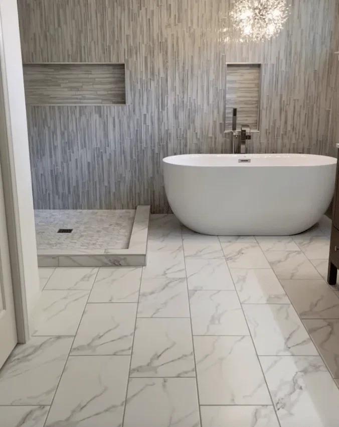 Modern bathroom with freestanding tub and mosaic tile wall