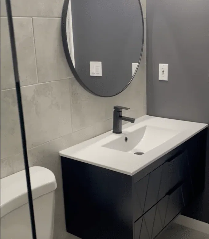 Modern bathroom with black fixtures and gray tiles