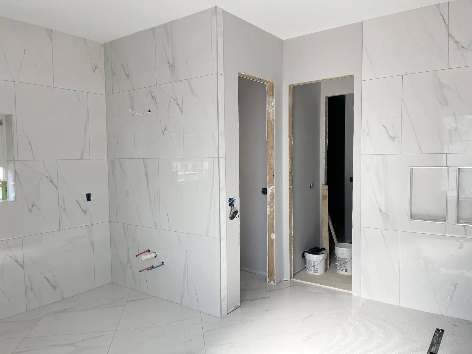 Partially finished marble tiled bathroom under construction