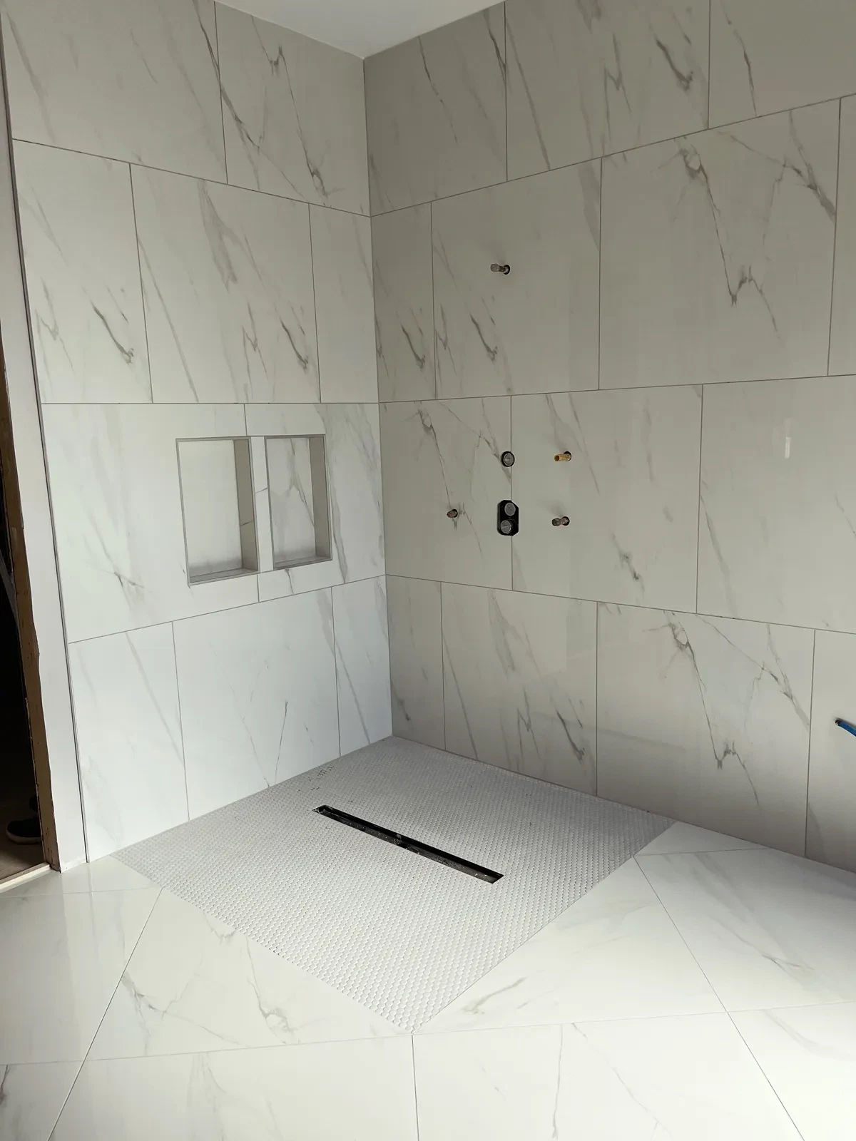 Modern bathroom with marble tiles and walk-in shower
