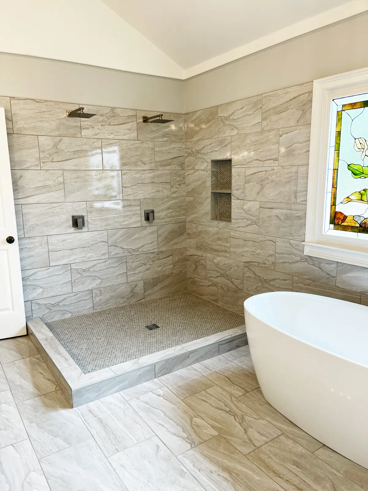 Modern bathroom with marble tiles and freestanding tub