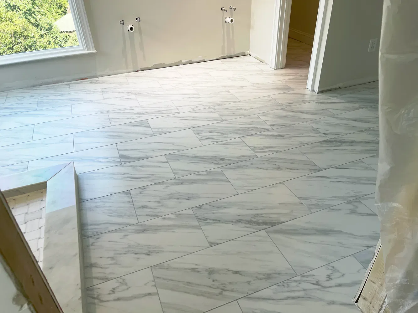 Newly installed white marble tiled floor in empty room