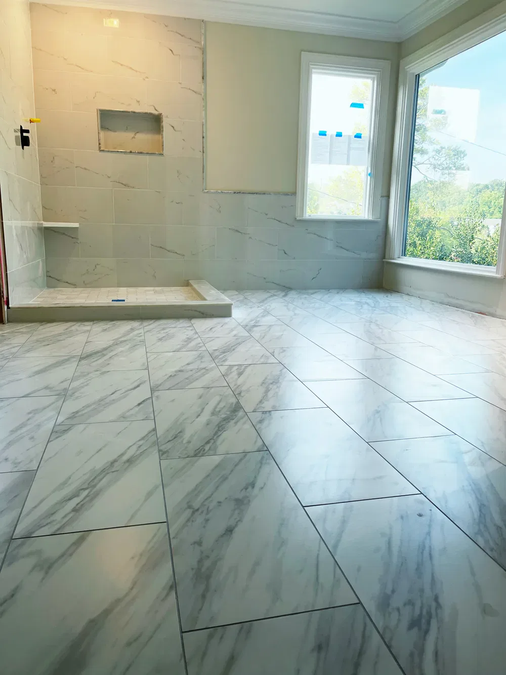 Bright bathroom under renovation with marble tiles