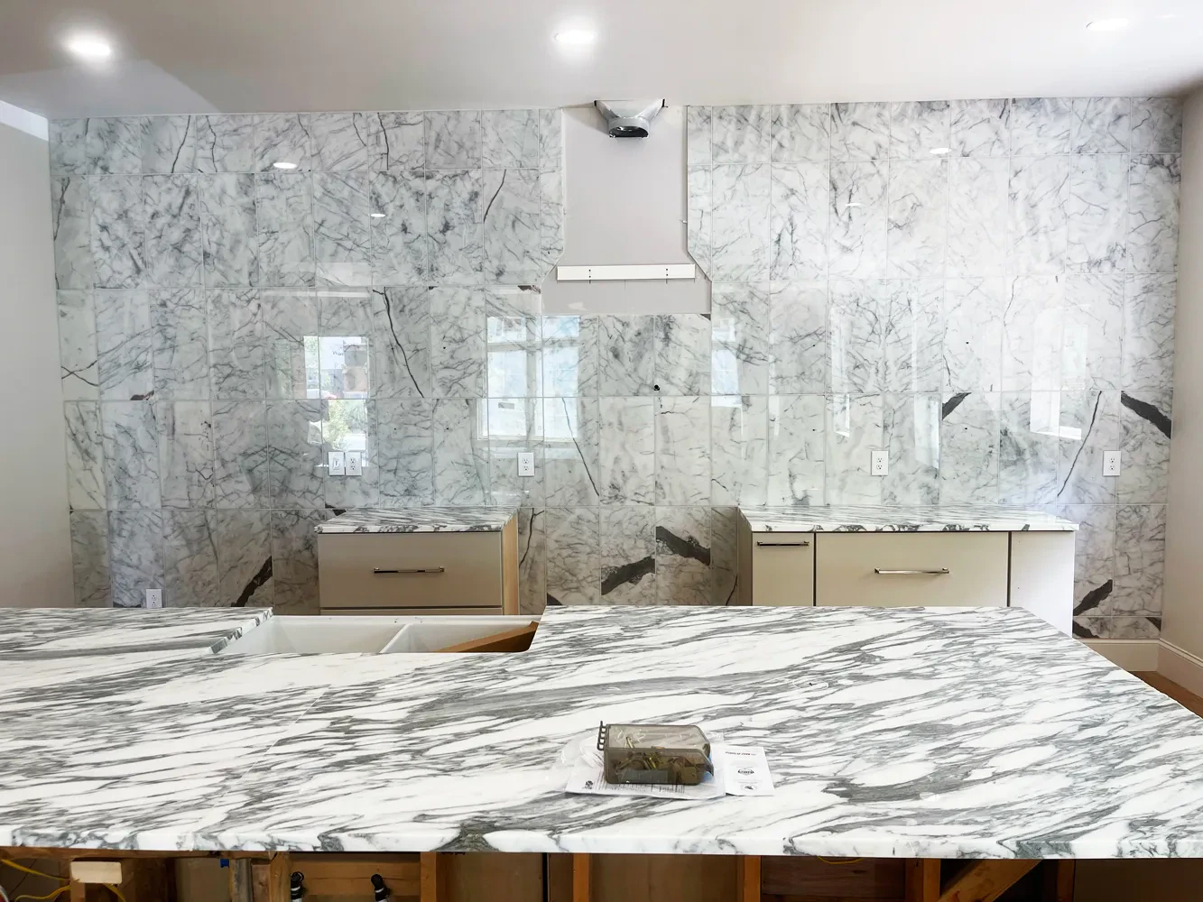 Modern kitchen with marble surfaces and cabinets