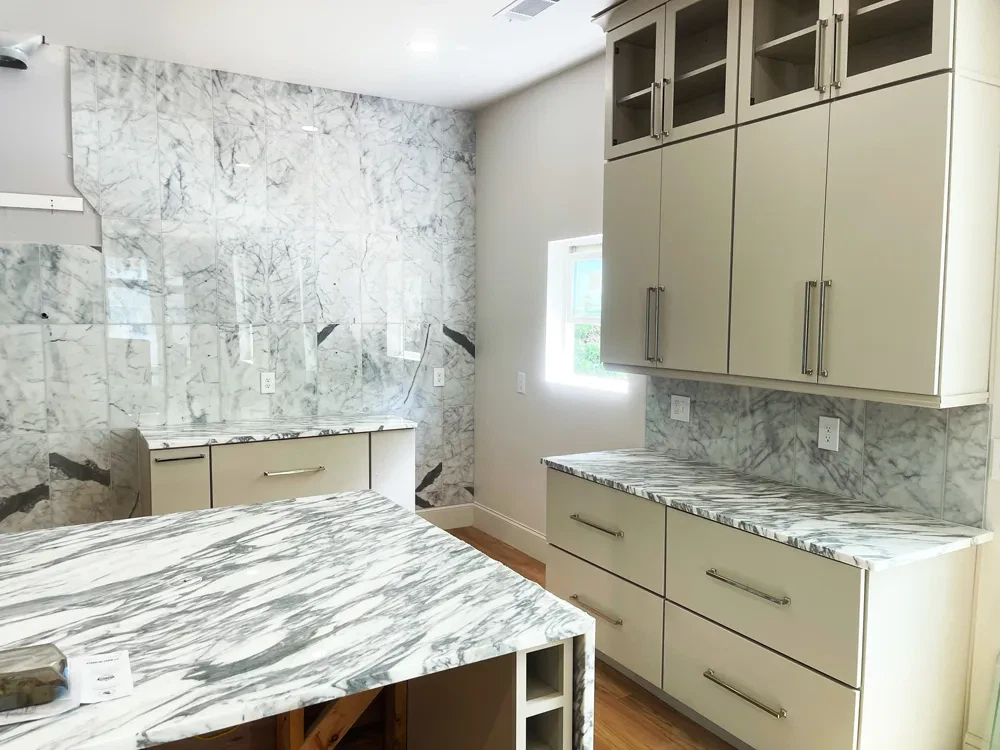 Modern kitchen with marble countertops and cabinets