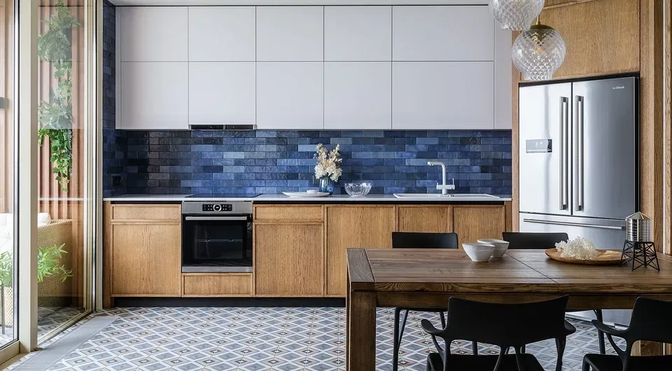 Modern kitchen with wooden cabinets and blue tile backsplash