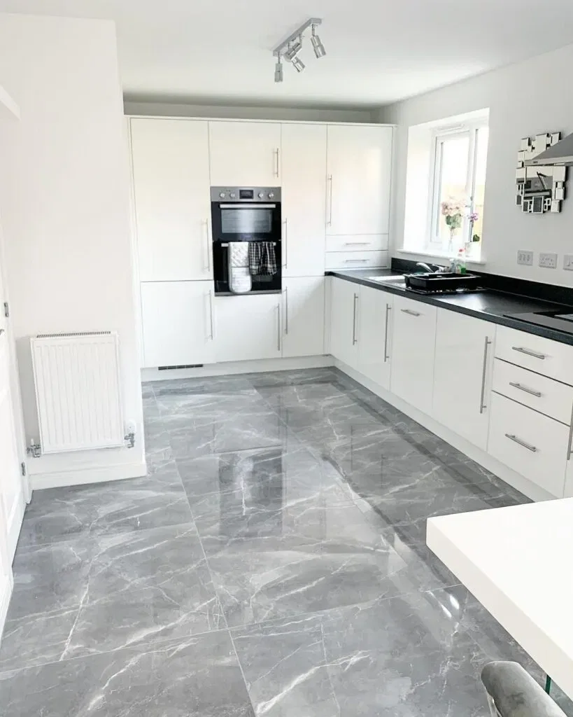 Modern kitchen with white cabinets and marble floor