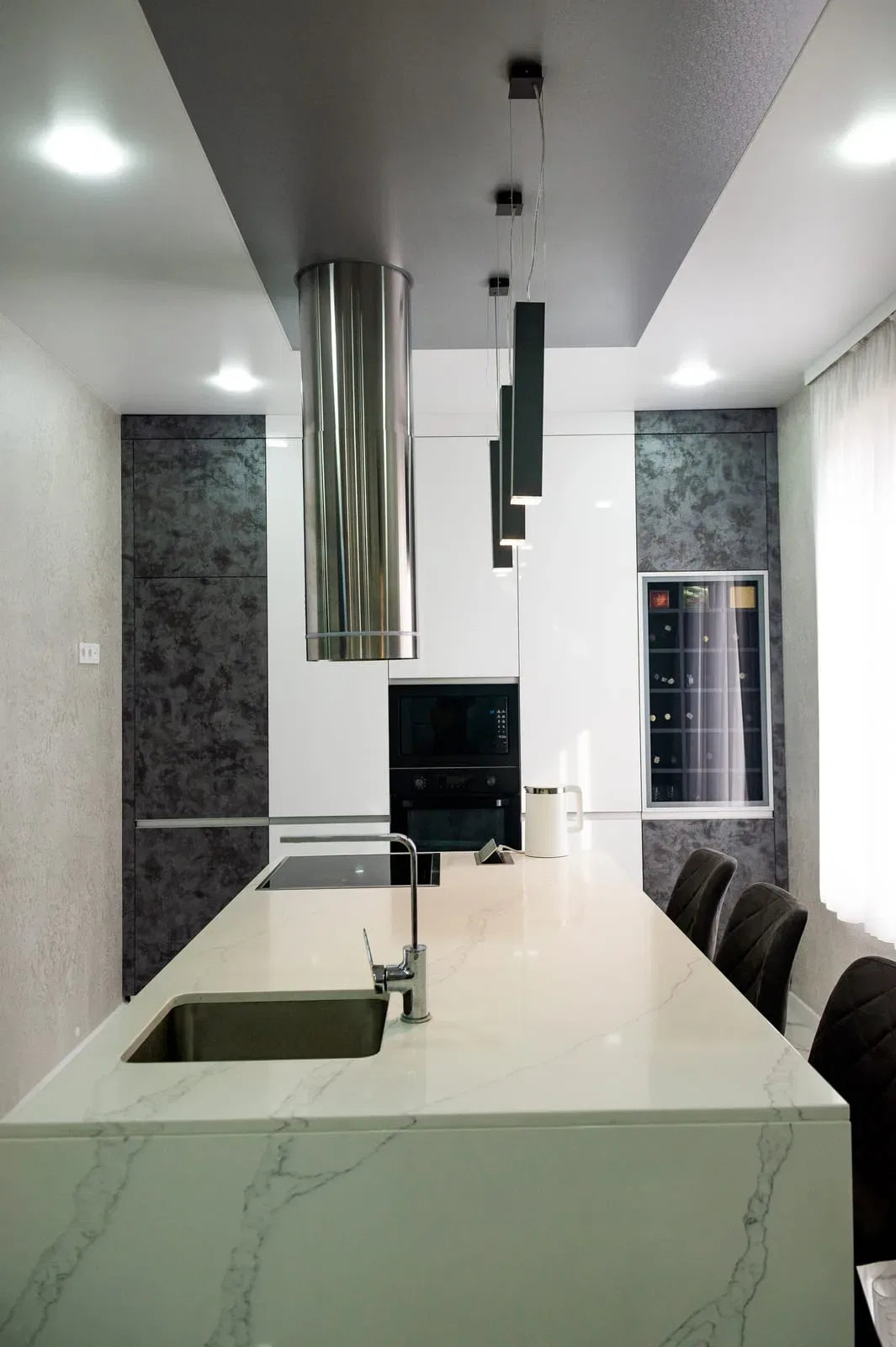 Modern kitchen with marble island and steel appliances
