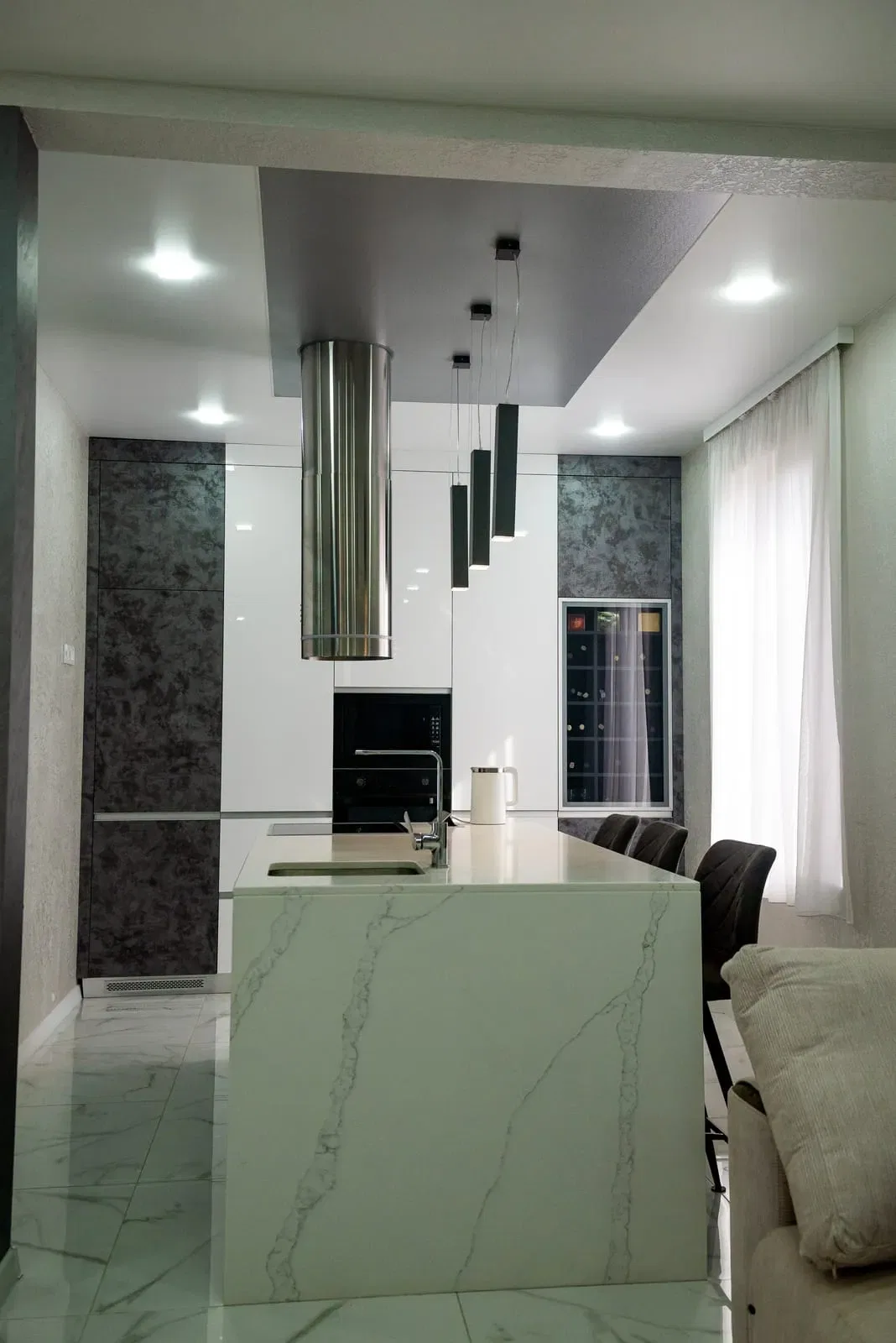 Modern kitchen interior with marble island and stainless appliances