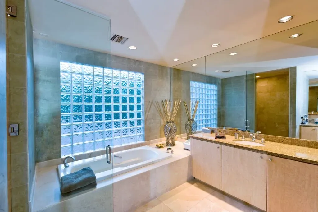 Spacious modern bathroom with glass block windows
