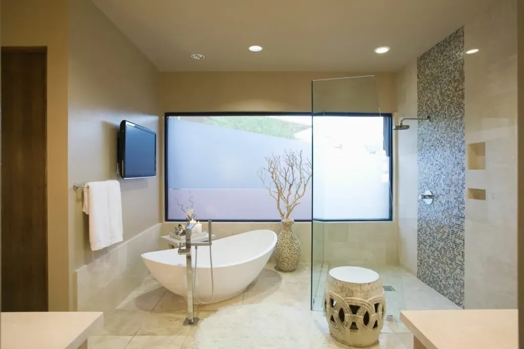 Modern bathroom with freestanding tub and large window