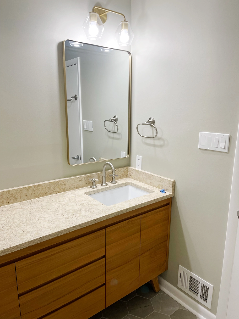 Modern bathroom interior with mirror and wooden vanity
