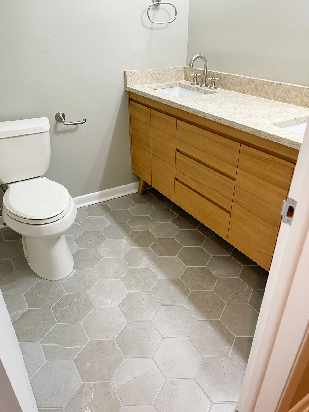 Modern bathroom with wooden vanity and hexagonal tiles