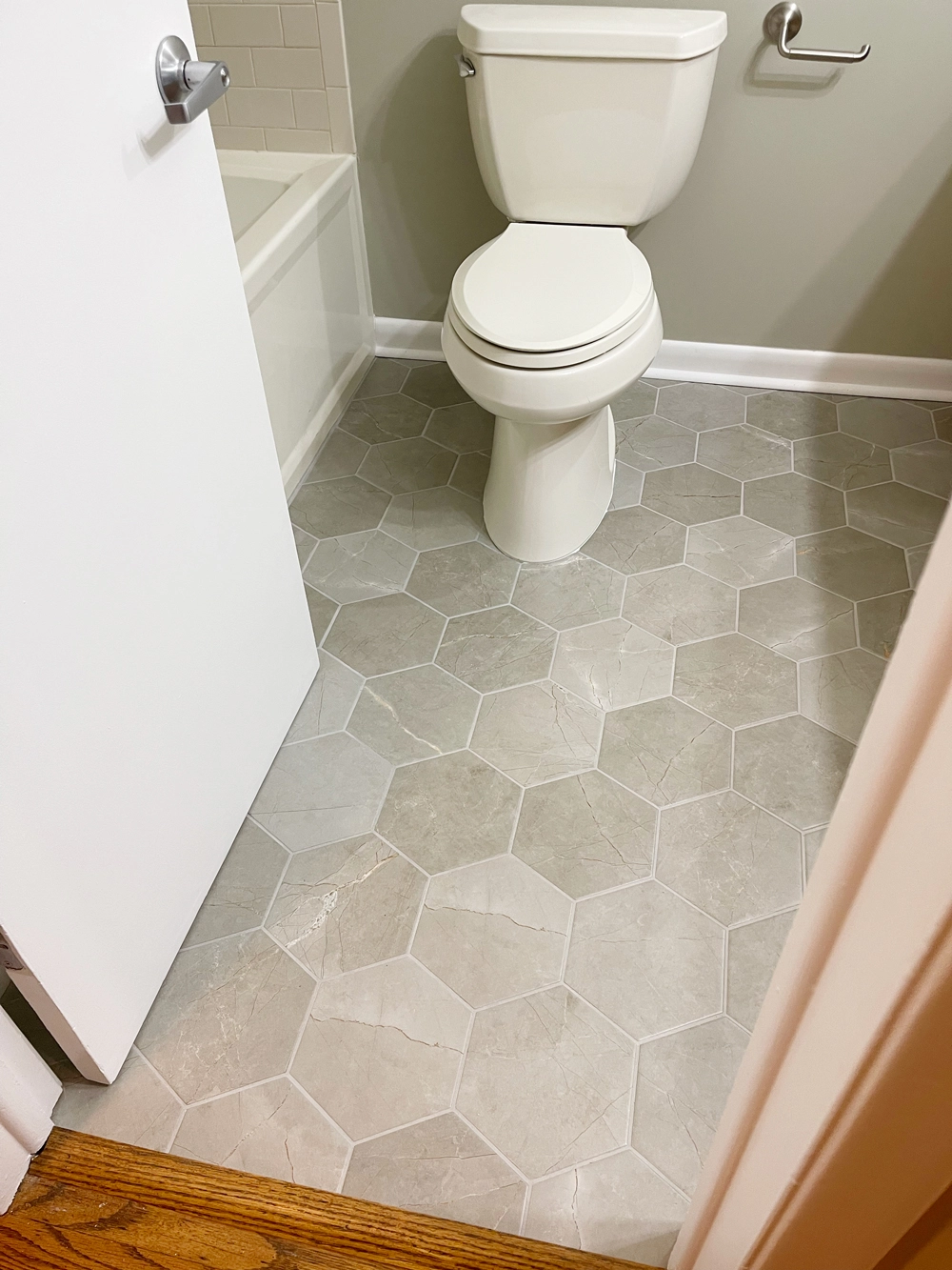 Modern bathroom with white toilet and hexagonal tile floor