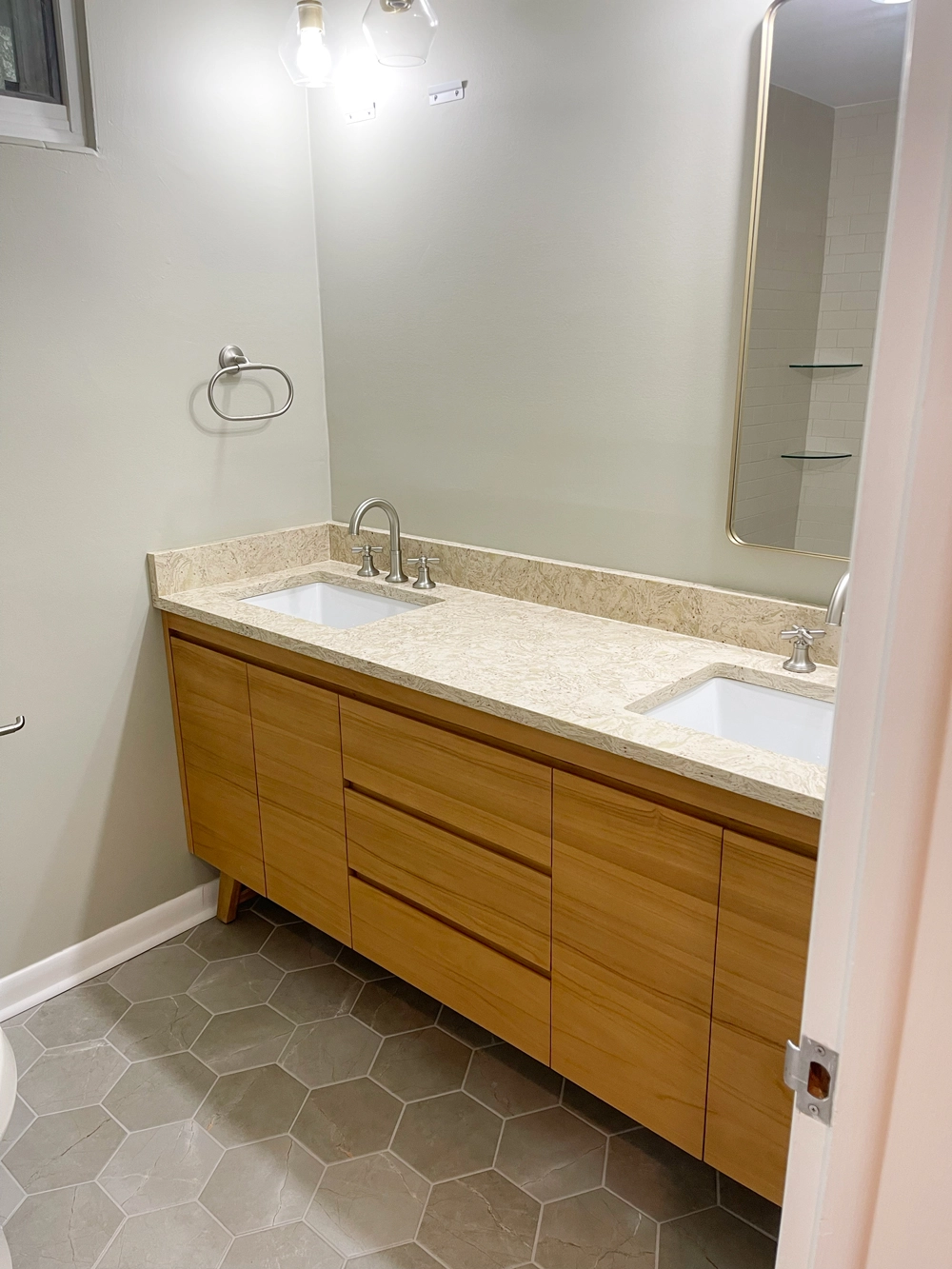 Modern bathroom with wooden vanity and hexagonal tiles