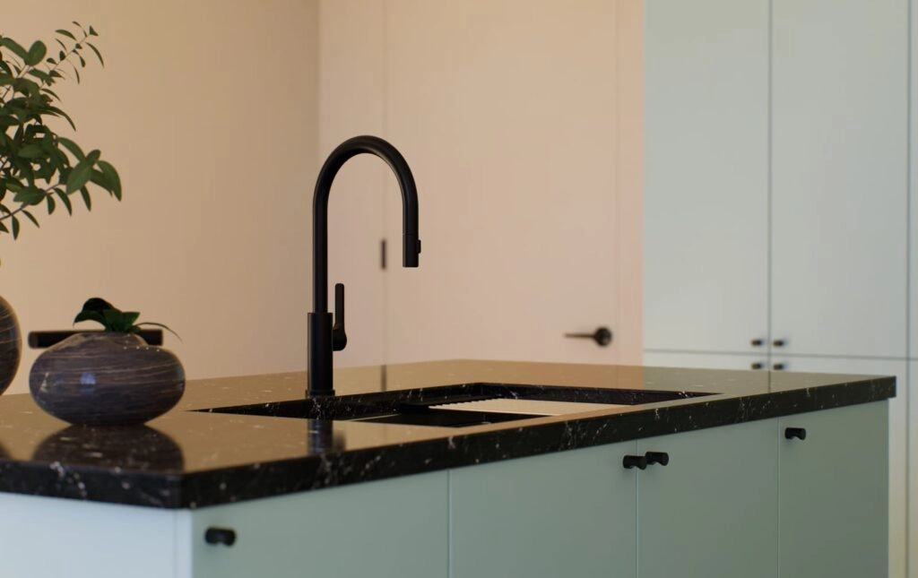 Modern kitchen sink with black faucet and marble countertop