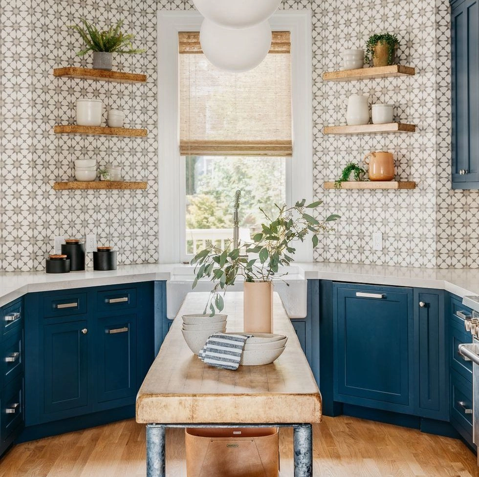 Stylish kitchen with blue cabinets and patterned tile backsplash