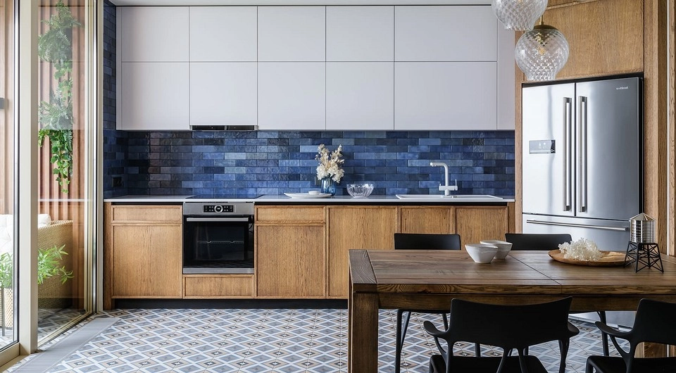 Modern kitchen with wooden cabinets and blue tile backsplash